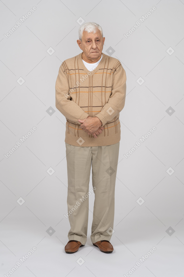 Vue de face d'un vieil homme en vêtements décontractés regardant la caméra