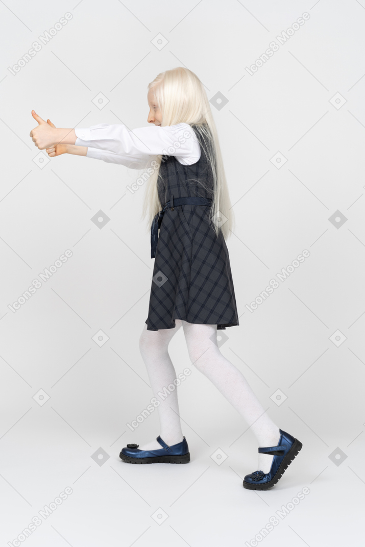 Schoolgirl giving thumbs up