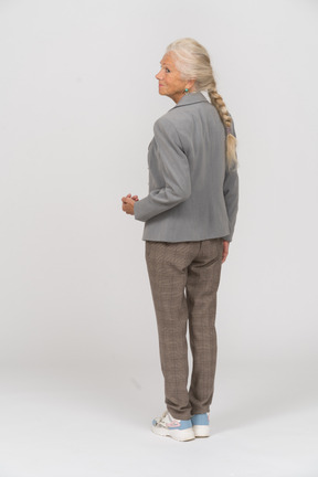 一位身穿灰色夹克的老妇人的后视图