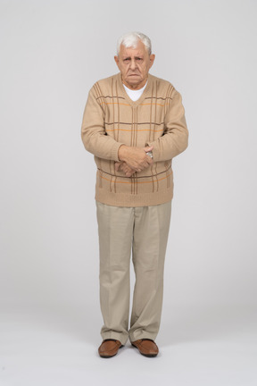 Front view of an old man in casual clothes standing still