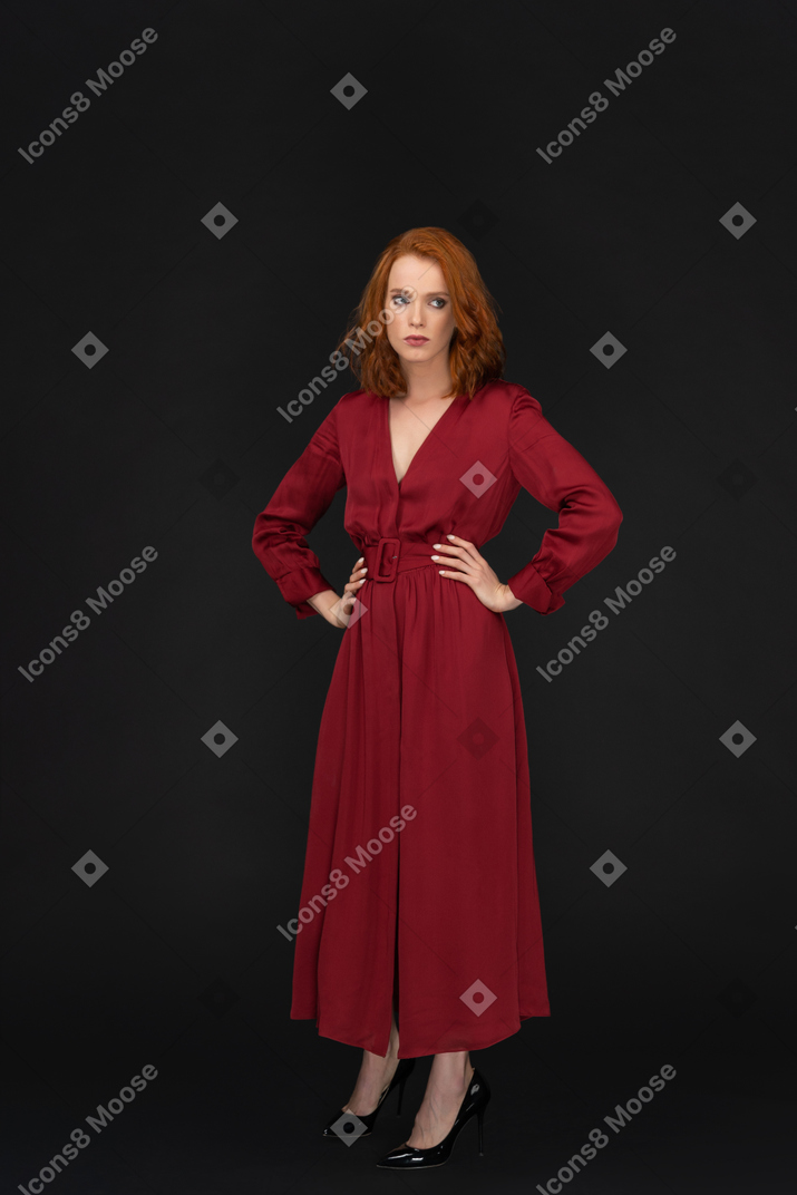 Young lady in red with arms akimbo