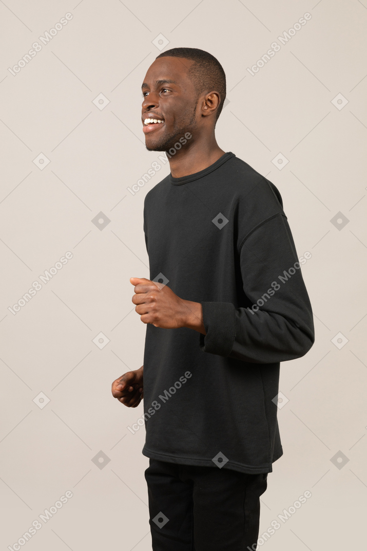 Happy young man running and smiling
