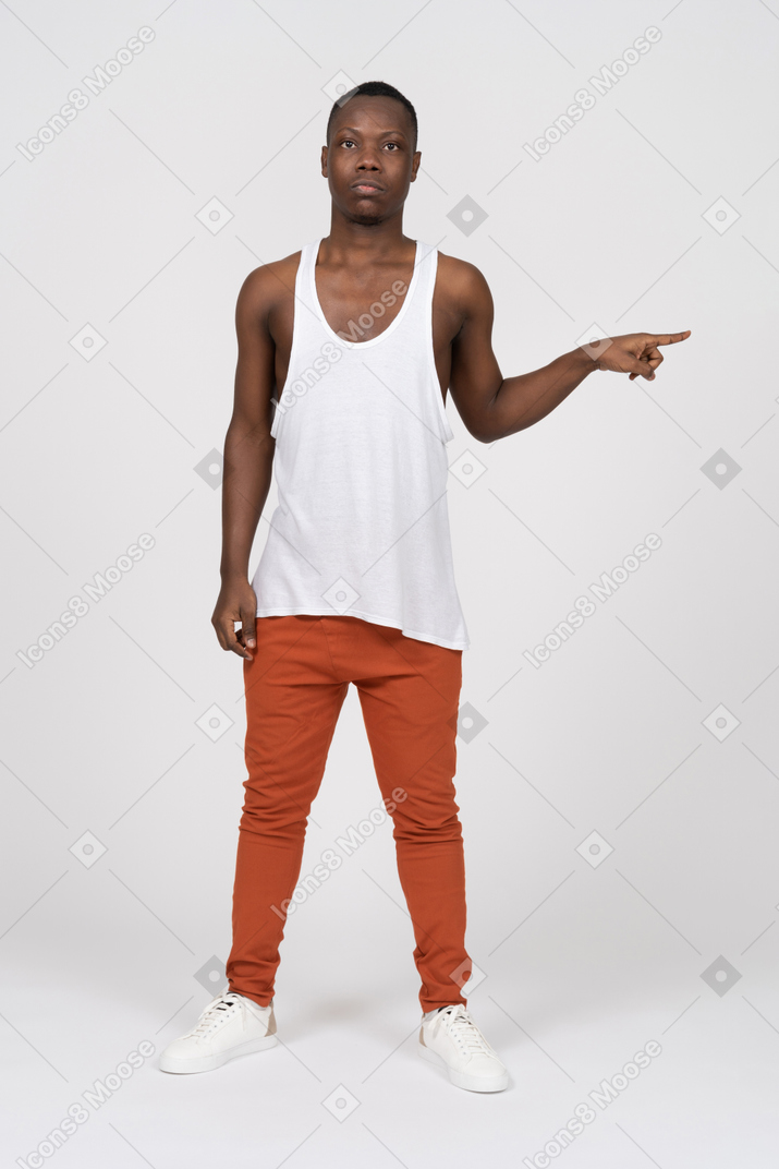 Young man pointing to side