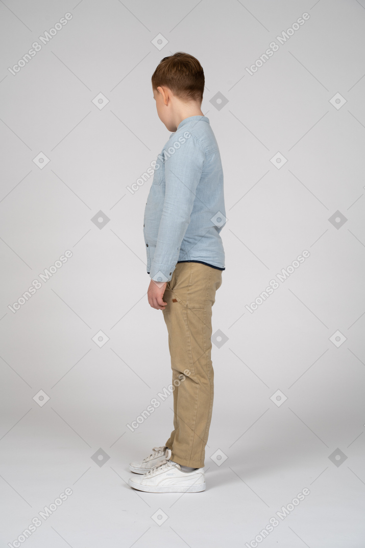 Side view of a cute boy looking down