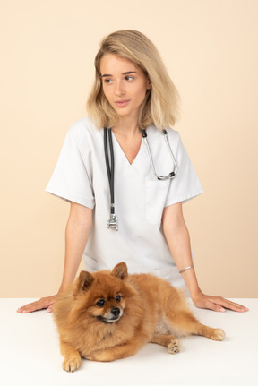 Attractive veterenarian ready to examine a spitz