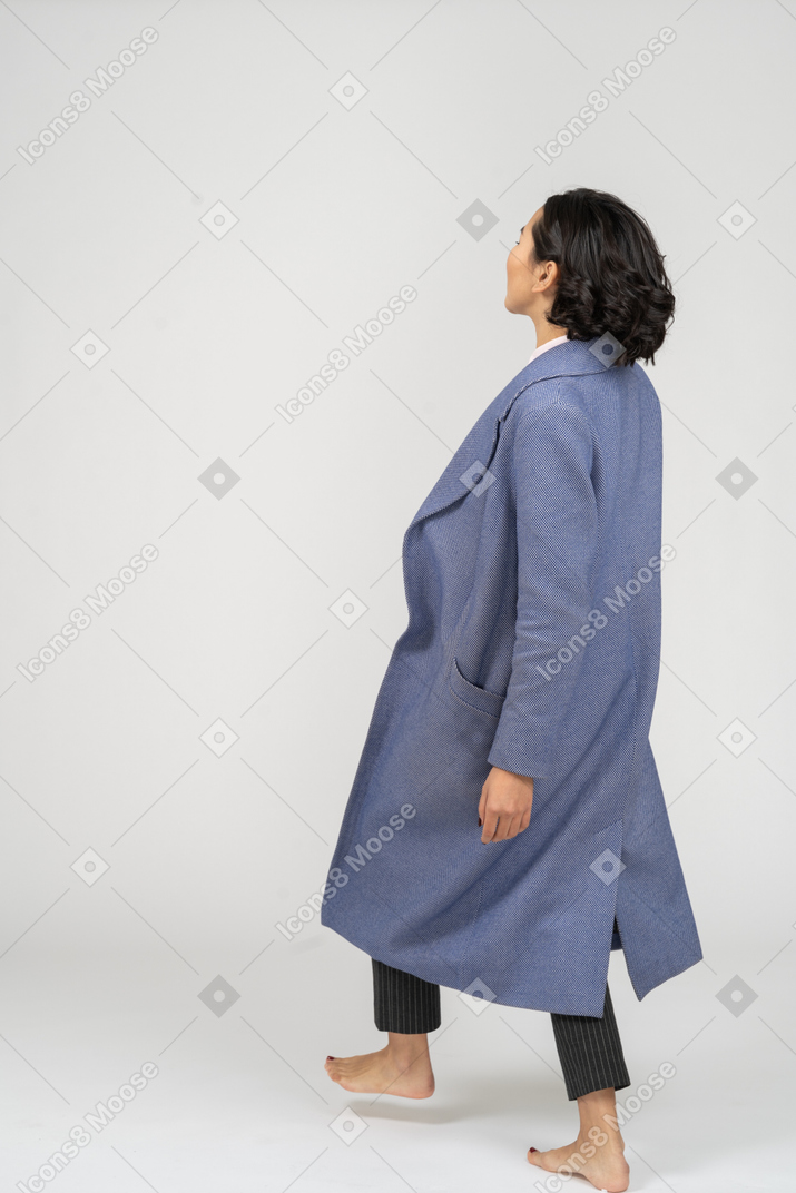 Back view of barefoot woman making step