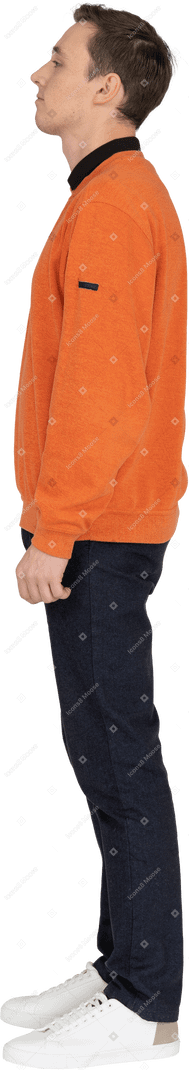 Young man in orange sweatshirt standing