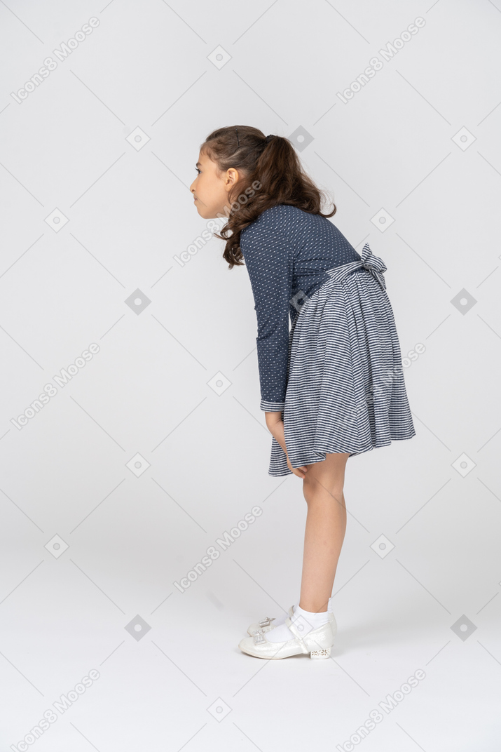 Side view of a girl slouching and looking puzzled