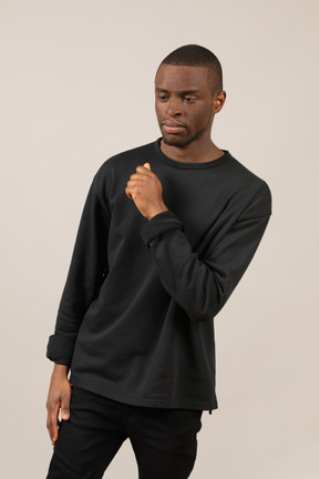 Pensive young man in black outfit