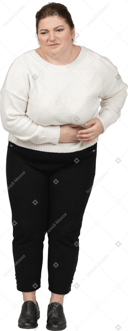 Plump woman in casual clothes suffering from stomachache