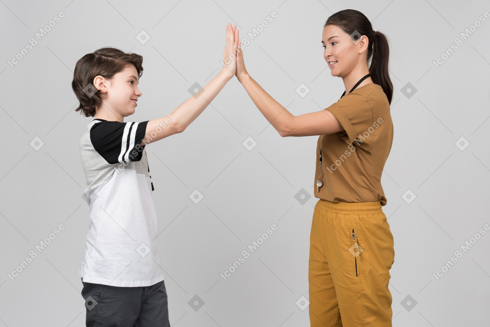 Pe teacher and pupil clapping hands together