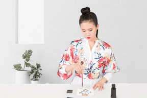 A woman in a kimono practicing calligraphy