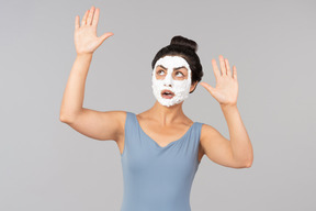 Woman with white mask on sending air kisses