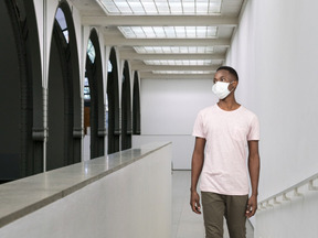 Young man wearing face mask and walking