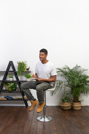 Good looking young man sitting on a chair