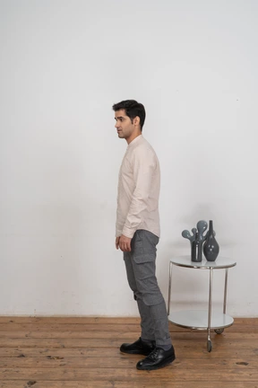 Man in casual clothes standing in profile