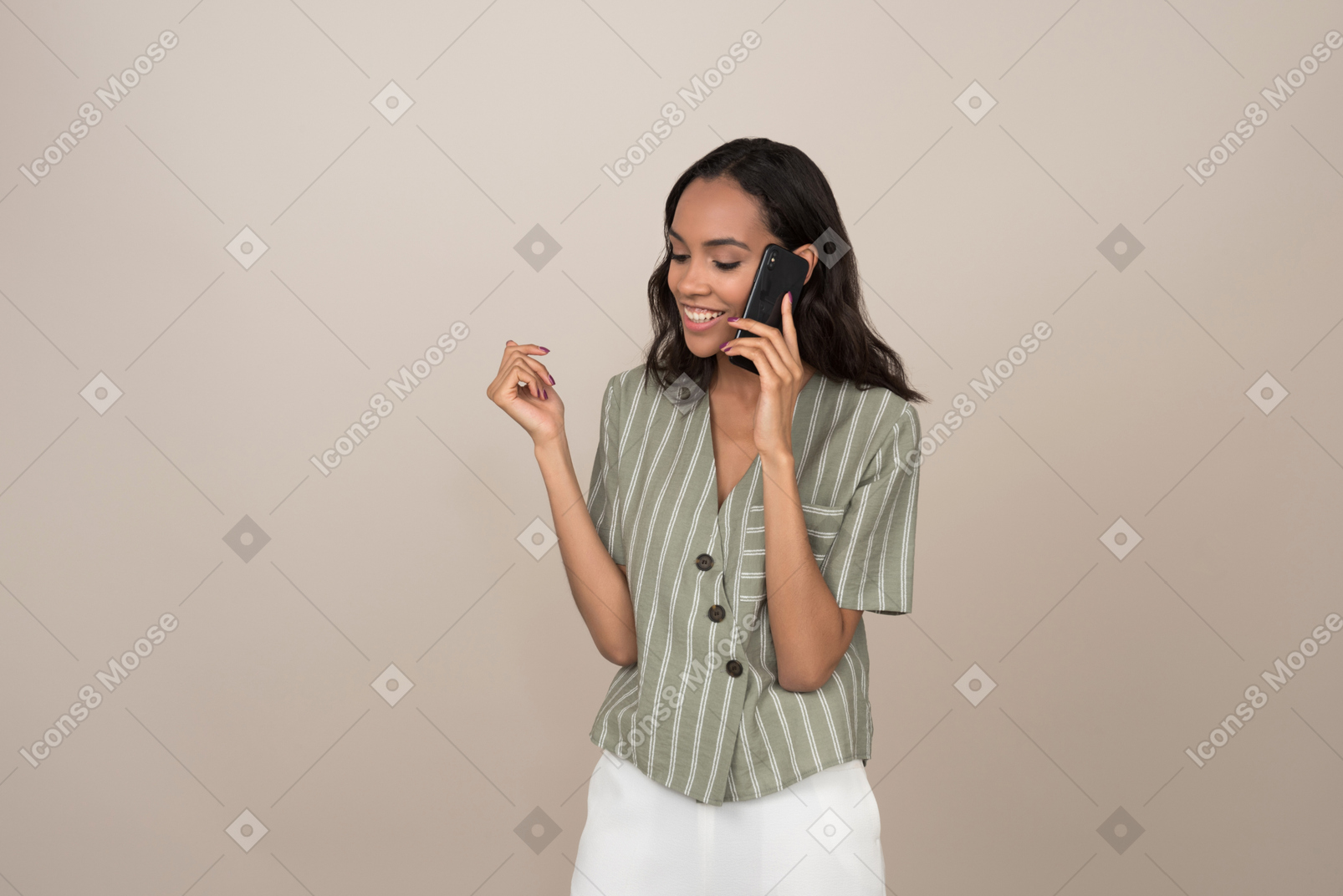 Pretty young girl talking on the phone and looking down
