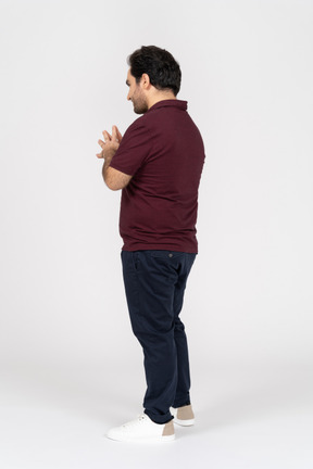 Three-quarter back view of man with folded hands