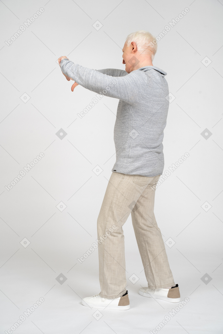 Side view of man giving thumbs down with two hands