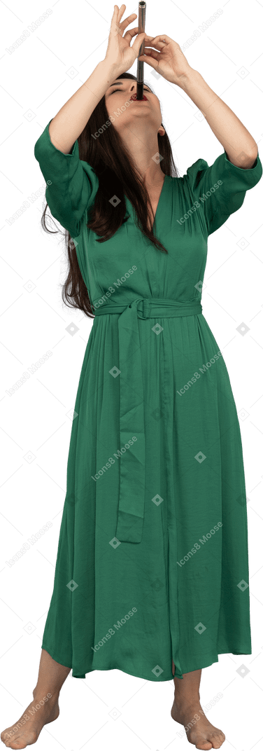 Front view of a young lady in green dress playing flute while leaning back