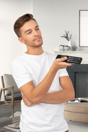 A man holding a remote control in his hand