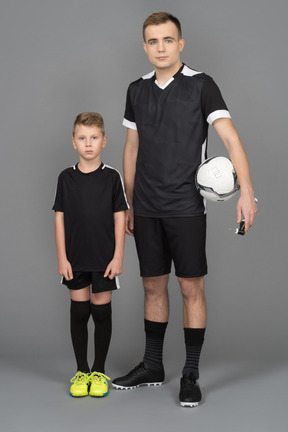 Full-length of a young man coaching little boy