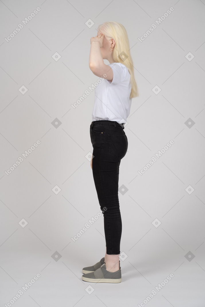 Side view of a woman saluting