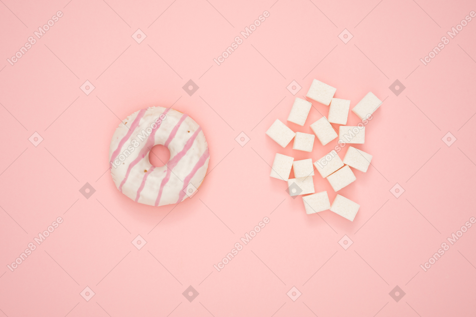 Donut and sugar cubes over pink background