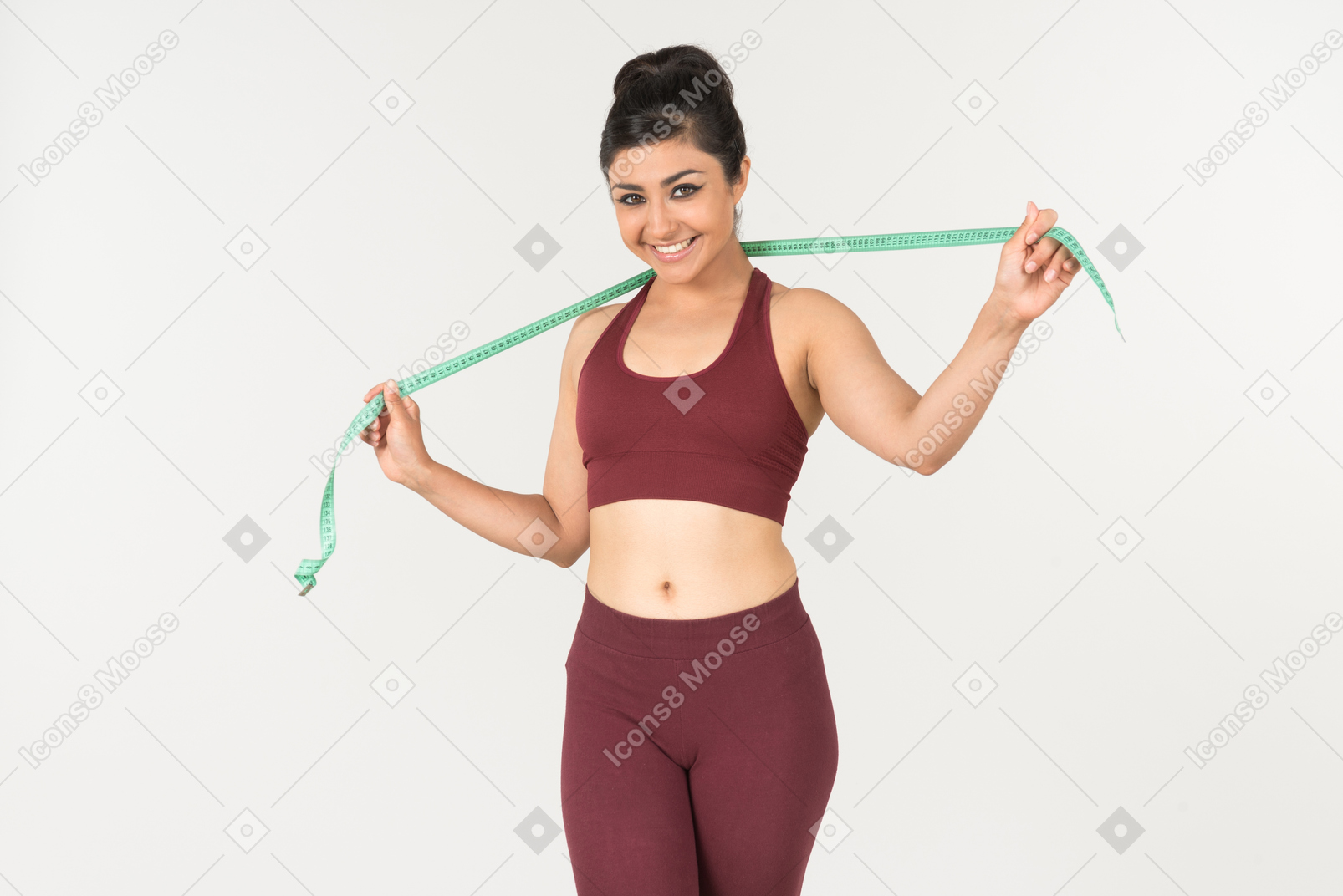 Young indian woman in sportswear holding cloth ruler