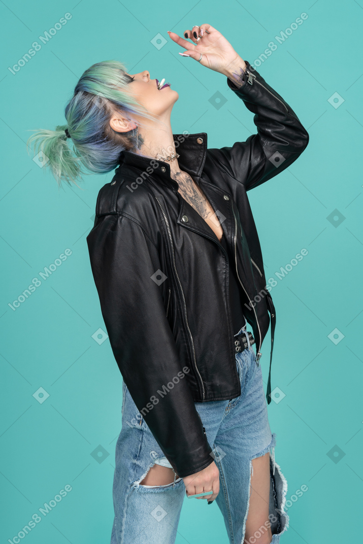 Punk woman putting something in her mouth
