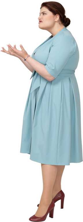 Vista lateral de uma mulher zangada em um vestido azul