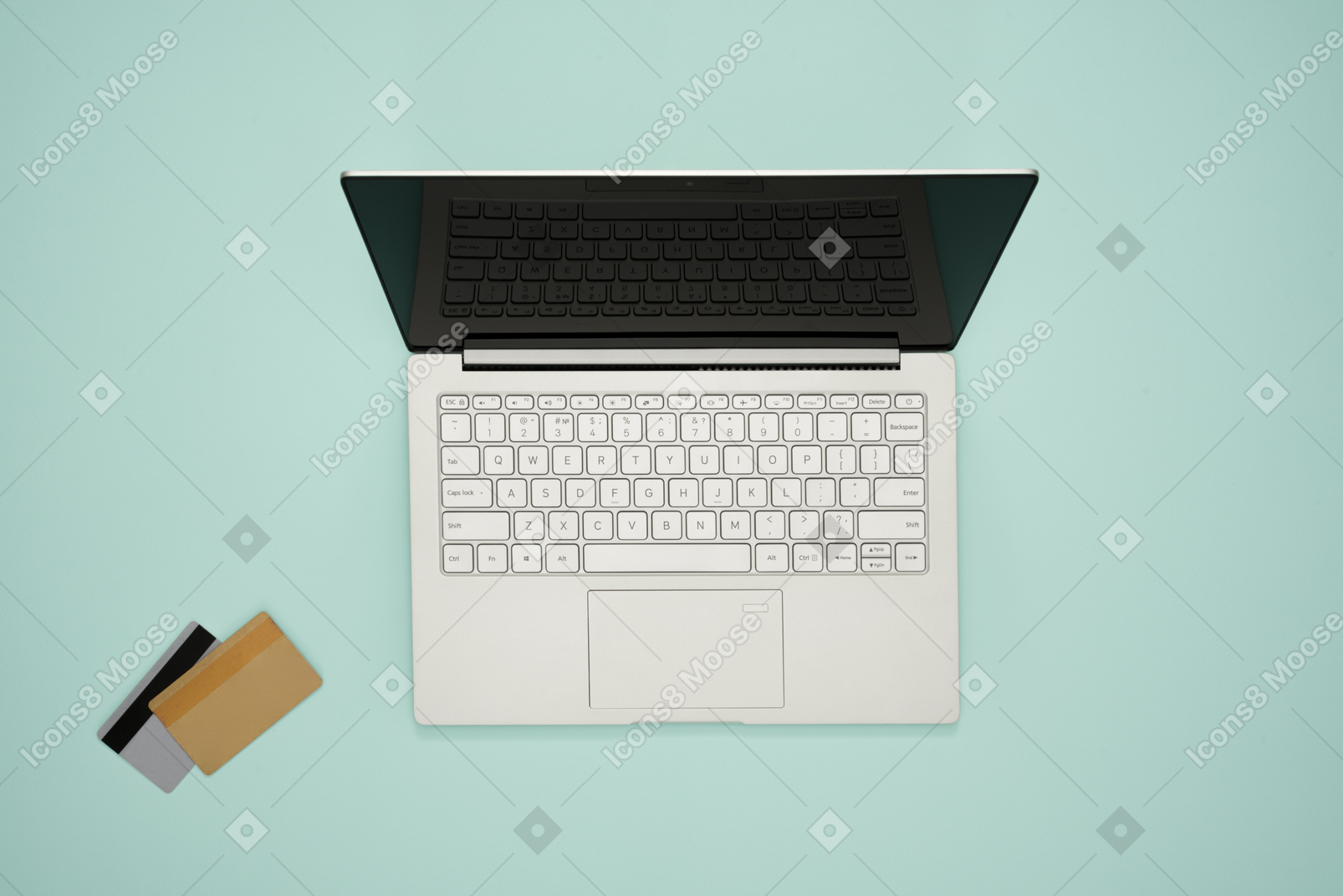 Laptop and credit cards on a turquoise background