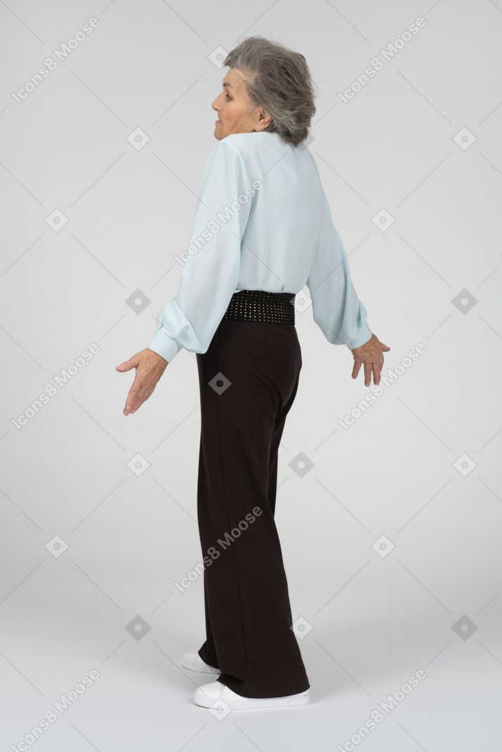 Indifferent-looking elderly woman shrugging her shoulders
