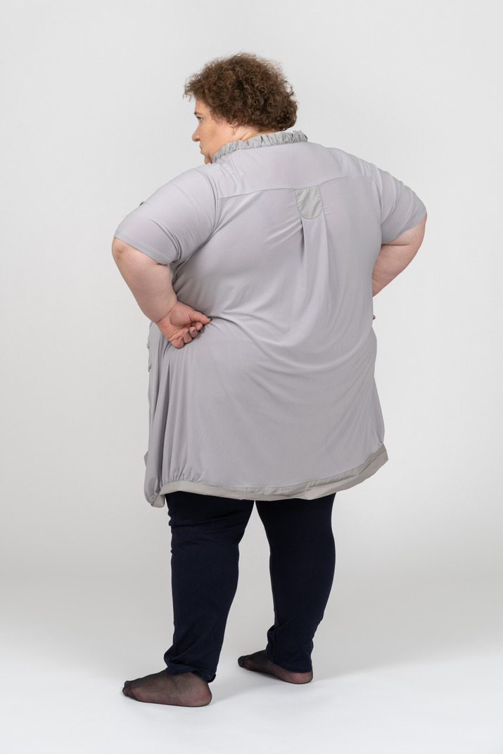 Rear view of an annoyed woman standing