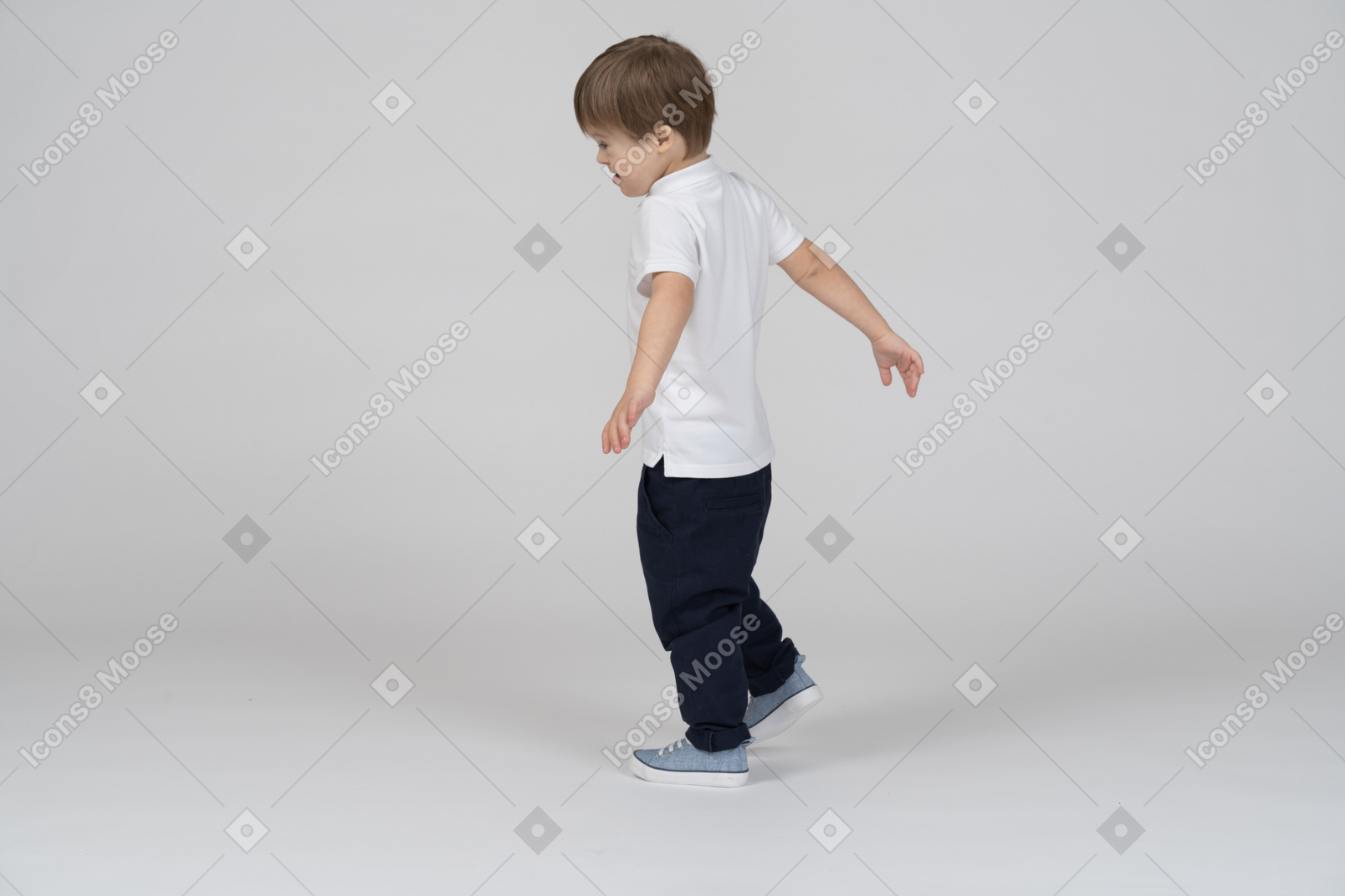 Three-quarter back view of a boy walking with flailing hands