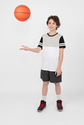 Boy throwing a basketball ball up