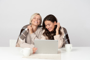 Young women watching movies and laughing