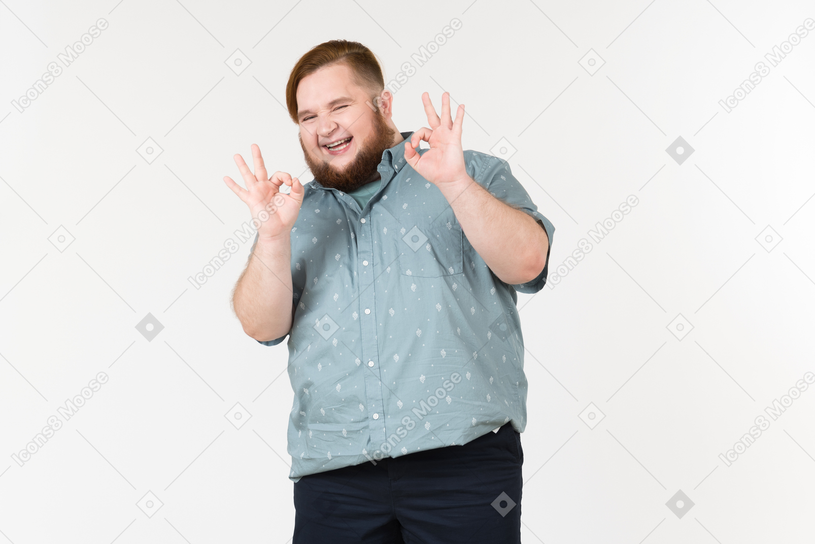 Laughing young overweight man showing ok gesture