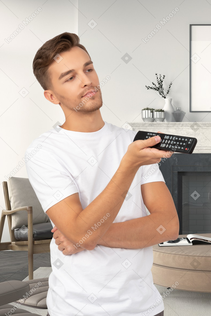 A man holding a remote control in his hand