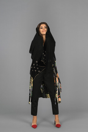 Cheerful arab woman wrapped in black headscarf