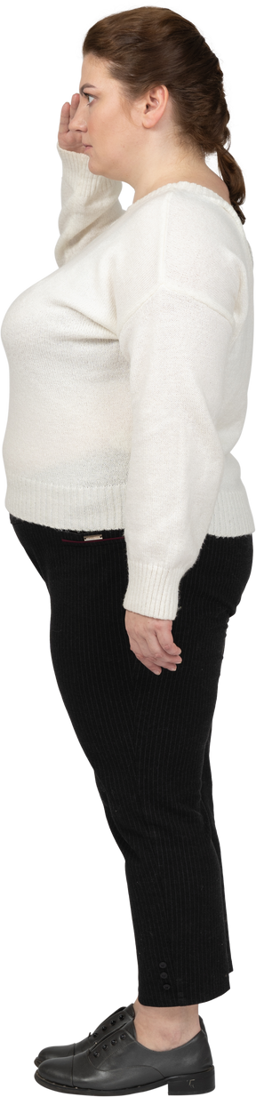 Side view of a plus size woman in casual clothes saluting with hand