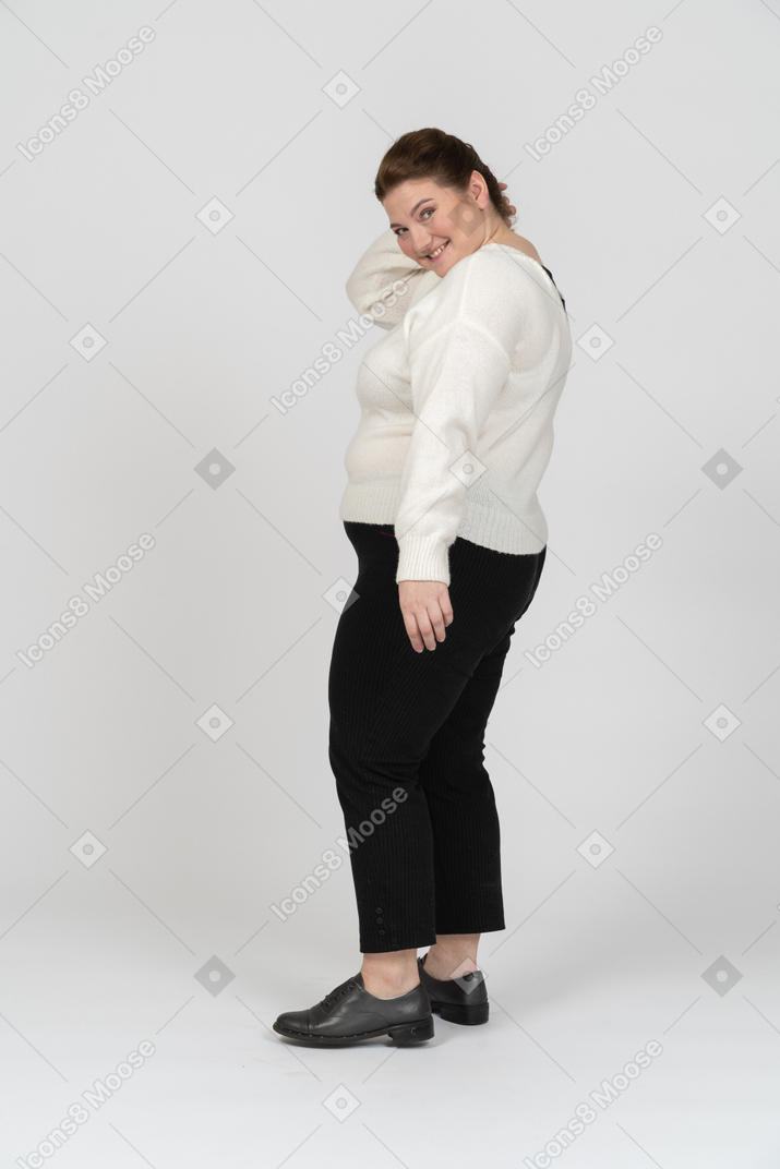 Happy plus size woman standing in profile