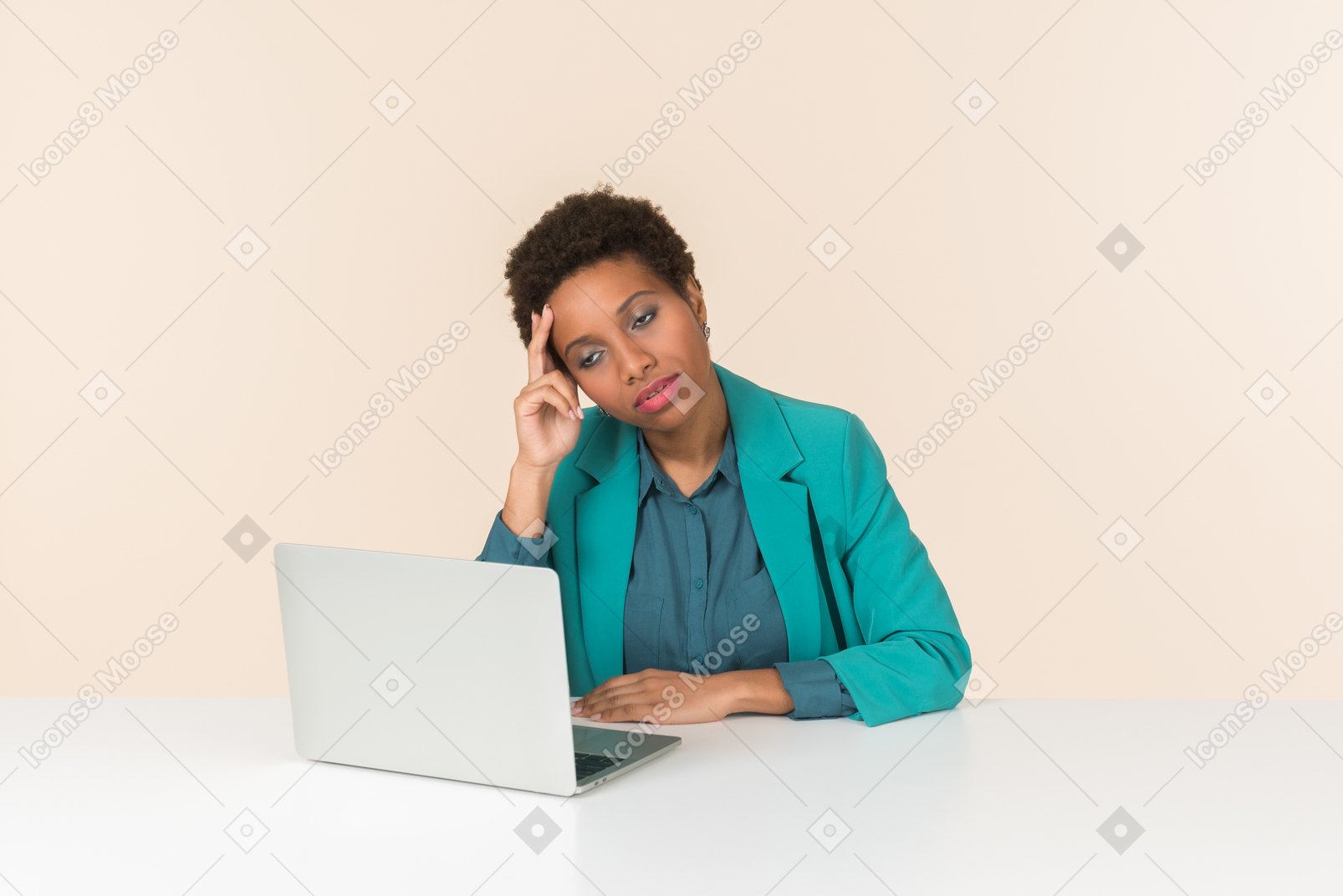 Pensive female office employee sitting in front of laptop