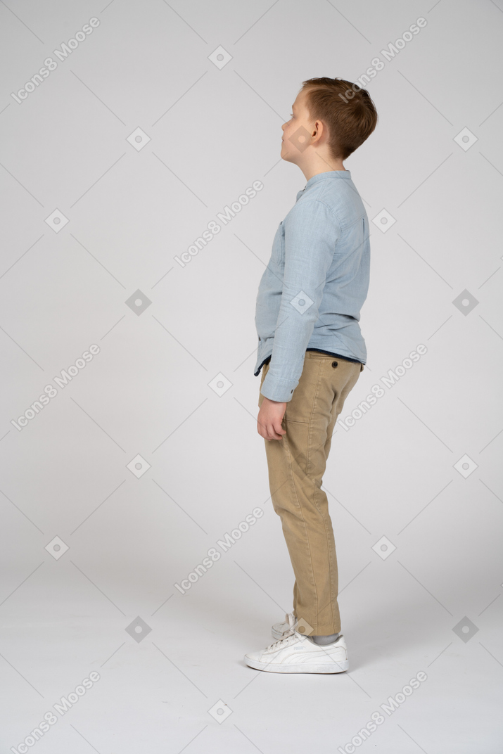 Side view of a cute boy looking up