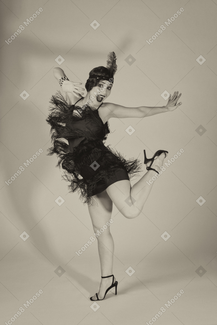Stylish excited flapper dancing alone