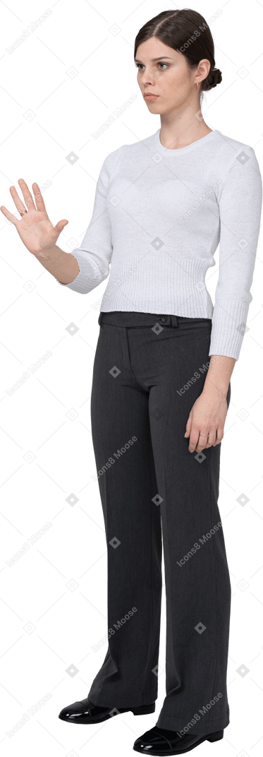 Vista de tres cuartos de una mujer joven en ropa de oficina extendiendo la mano