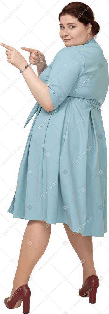 Side view of a woman in blue dress pointing with fingers