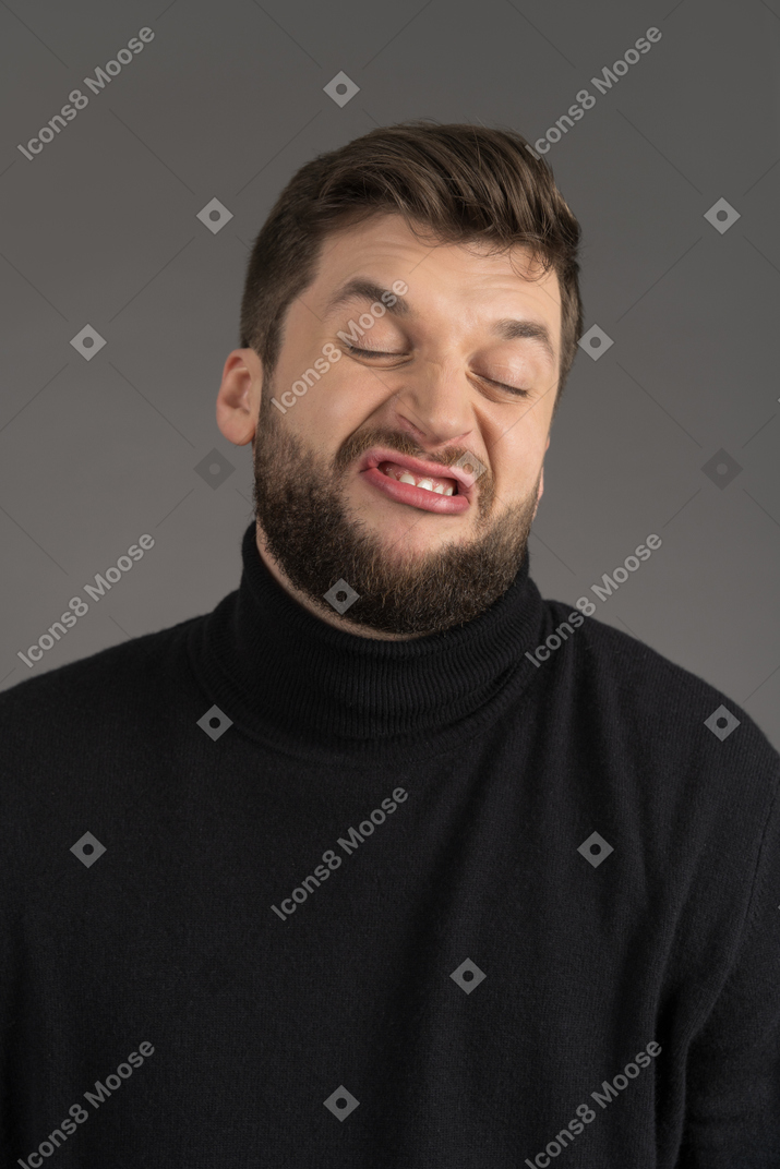 Expressive young man making faces