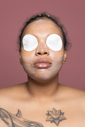 African-american woman with moisturizing eye pads