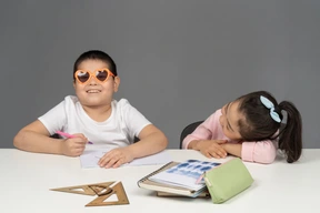 Girl laughing at her brother wearing sunglasses